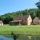 Property in Périgord Noir comprising a house and two cottages on an adjoining plot of land of about 2.8 hectares with a pond and tennis court.